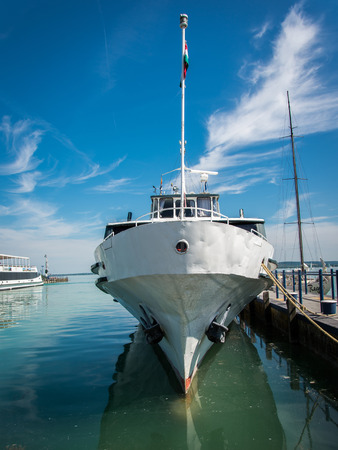 Boat in harbor with cloudy skyの写真素材