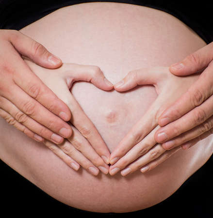 Pregnant couple with heart shape
