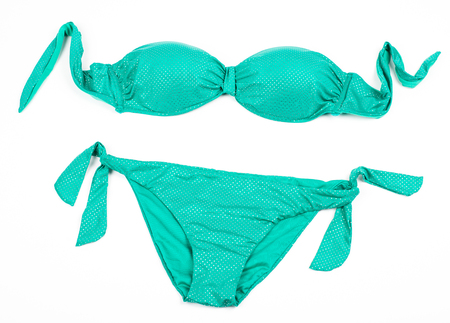 Turquoise shiny bikini isolated on whiteの写真素材