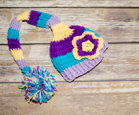 Striped baby hat on woodの写真素材