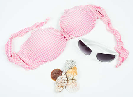 Pink bikini top with sunglasses isolatedの写真素材