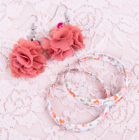 Two earrings on pink laceの写真素材