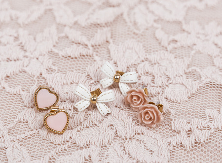 Three earrings on pink laceの写真素材