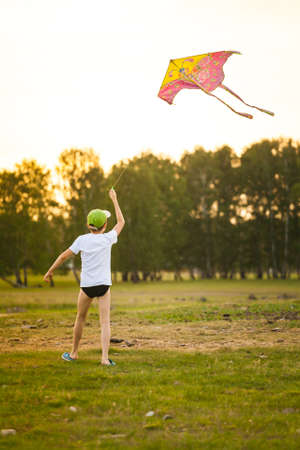 Happy child with a kite in the countrysideの写真素材