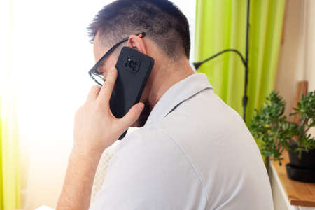 A man works on a computer remotely from home
