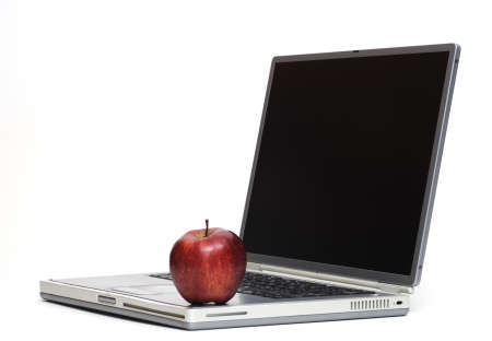 Apple sitting on a laptop