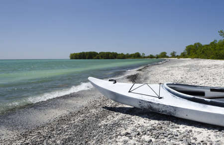 Selective focus on the bow of a kayak resting on the shoreline of Lake Ontarioの写真素材