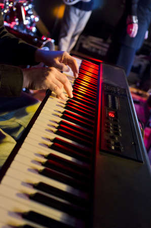 Selective focus on the hands on the keyboard at a blues festivalの写真素材