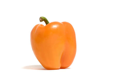 A single orange pepper isolated on a white backgroundの写真素材