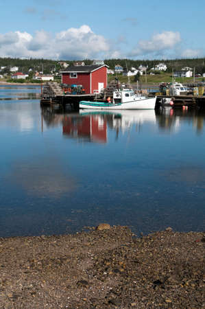 Lobster boat reflection in the harbour on a summer morning, located in Nova Scotia, Canadaの写真素材