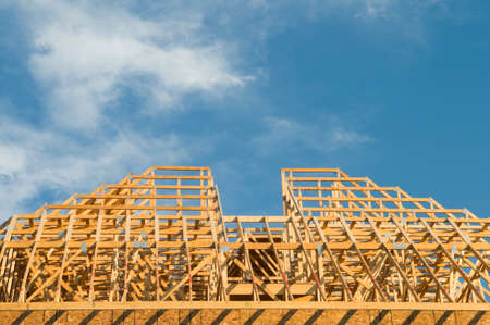 Wood construction framing of a building roof with copy space in the skyのeditorial素材