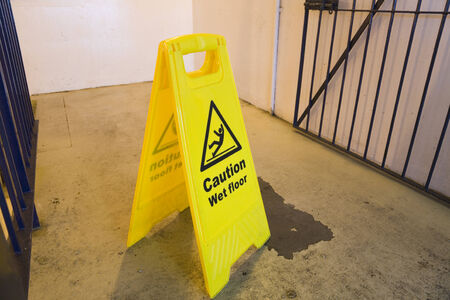 Wet floor hazard sign - yellow with caution symbolの写真素材