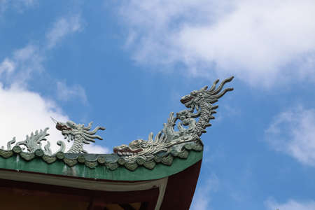Dragon carving on a roof topの写真素材