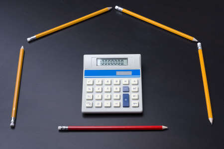 Pencils as house with calculator door as a business, finance, mortgage concept. 10,000,000 on calculator.の写真素材