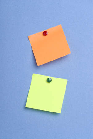 Two post it notes with drawing pins on blue background