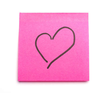 Post it note with heart symbol as concept for office romance. Suitable for St Valentine's Day