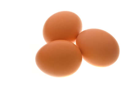 Group of 3 hen's eggs on white shot on light table.