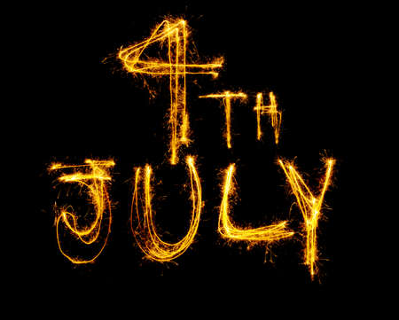 4th July written in sparklers isolated on blackの写真素材