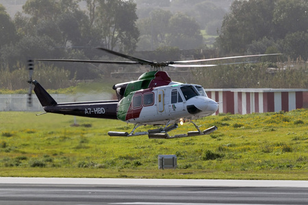 Luqa, Malta - February 5, 2015: Gulf Helicopters Bell 412EP arriving runway 31 after a flight to an oil rig in the Mediterranean.のeditorial素材