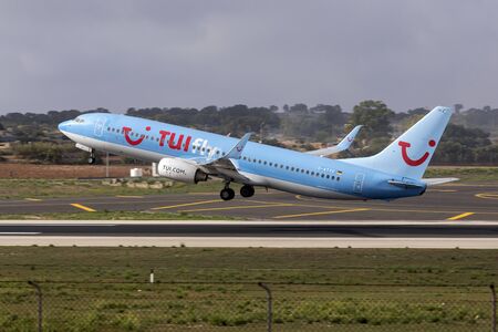 Luqa, Malta - September 23, 2019: TUIfly Boeing 737-8K5 (REG: D-ATYC) on take off from runway 13 in the morning.のeditorial素材
