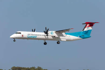 Luqa, Malta - August 15, 2020: Luxair Bombardier Dash 8-Q402 (LX-LQJ) on finals runway 31 arriving...