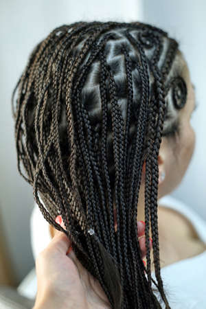 patterns on the head of thin plaits in a girl, a hairdress of aの写真素材