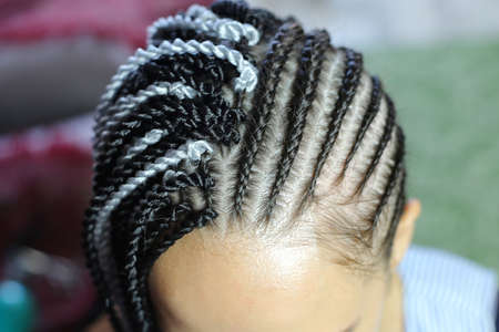 process of attaching Senegal braids to dreadlocks, African hairs