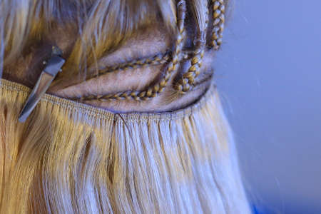 process of sewing artificial hair on a tape to a pigtail