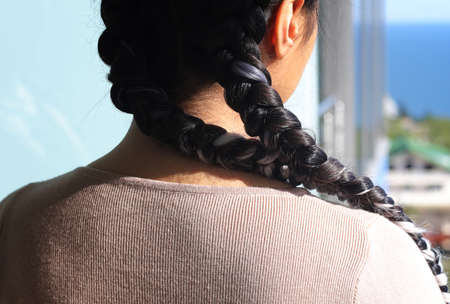 fashionable hairstyle of two braids with a kanekalon on a figureの写真素材