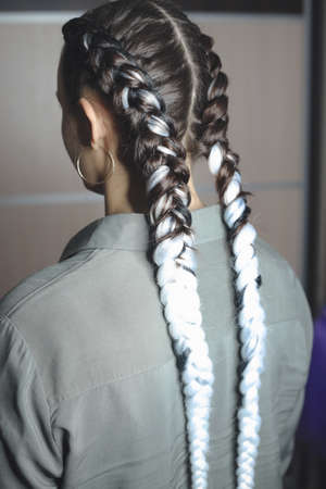 two large braids on the head of a girl, braided hair with artificial material kanekalonの写真素材