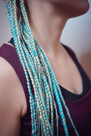 cornrows women A woman with a haircut on a white background, tight braids braided into a tail,...