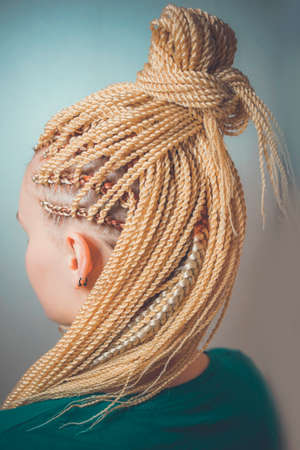 female pigtails, Senegalese braid braid, kanekalon, afrokosy, pigtails on the temple, creative youth hairstyleの写真素材