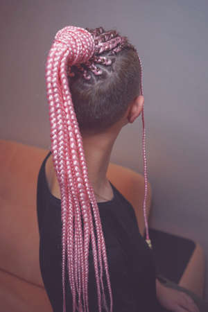 cornrows women pigtails collected in the ponytail on the head of the girl, the work of the master, pink hairの写真素材