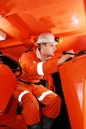 Miner in the drilling machine cockpit stock photo