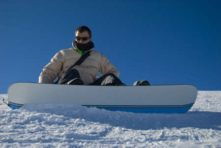 Snowboarder portrait on a blue sky stock photoの写真素材