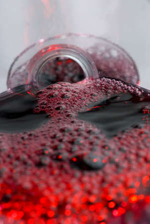 Wine pouring in a glass captured from unusual POV inside the bottle stock photoの写真素材