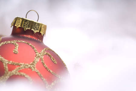 Red Christmas ball on snow close-upの写真素材