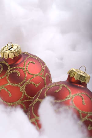Red Christmas balls close-up on snow verticalの写真素材