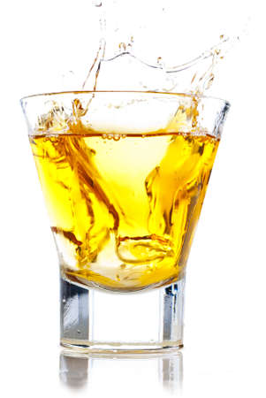 Splash of whiskey on the rocksの写真素材