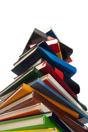 Hardcover Books stacked one over the other isolated on whiteの写真素材