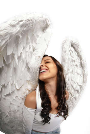 Young woman standing with angel wings isolated on white taken with wide angle lensの写真素材