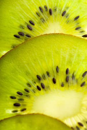 Slices of kiwi closeup backlit with seedsの写真素材