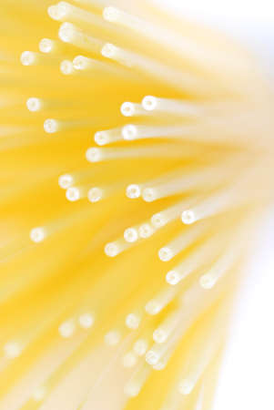 Macro shot of yellow spaghetti on a white background