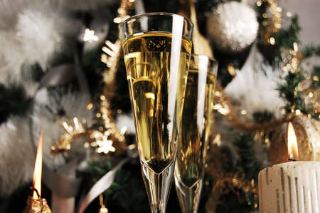 Topped champagne glasses on christmas backgroundの写真素材