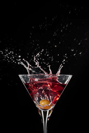 Red Cocktail amazing splash in high contrast isolated on blackの写真素材