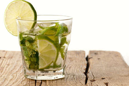 Green mojito with a slice of green lime isolated on whiteの写真素材