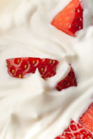 White whipped cream vanilla with pieces of strawberryの写真素材
