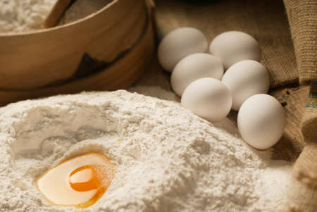 Egg yolk closeup in a heap of white flourの写真素材