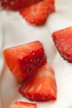 White yoghurt with large red strawberry piecesの写真素材