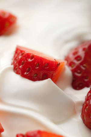 Pieces of strawberries in white whipped vanilla creamの写真素材